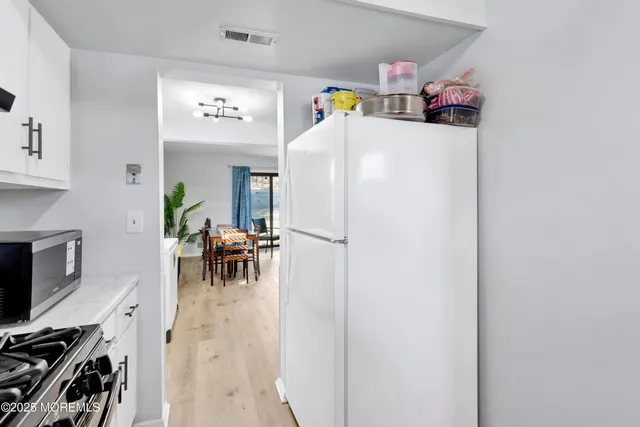a white refrigerator freezer sitting inside of a kitchen
