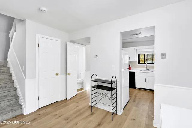 a view of kitchen with furniture and wooden floor