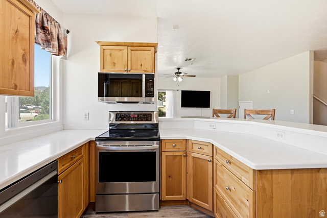 1177 Northfield Road, Unit 26 Cedar City, UT 84721 - Photo 12 of 45 Kitchen featuring light wood cabinetry, white countertops, stainless steel appliances, and a window with outdoor scenery