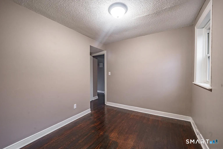 73 Silver Street Middletown, CT 06457 - Photo 21 of 30 an empty room with wooden floor and windows