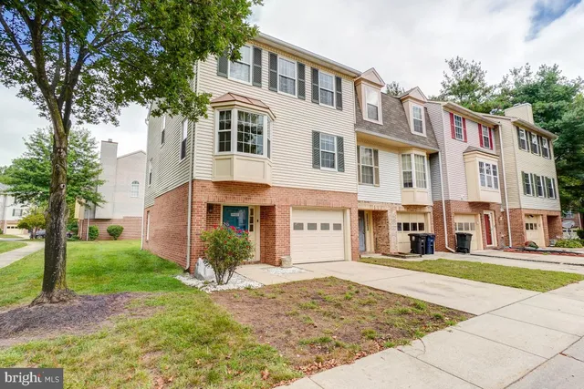 a front view of a building with a garden