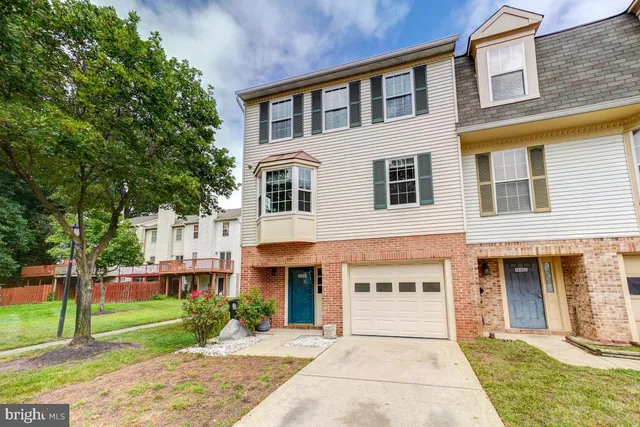 a front view of a house with a garden and plants