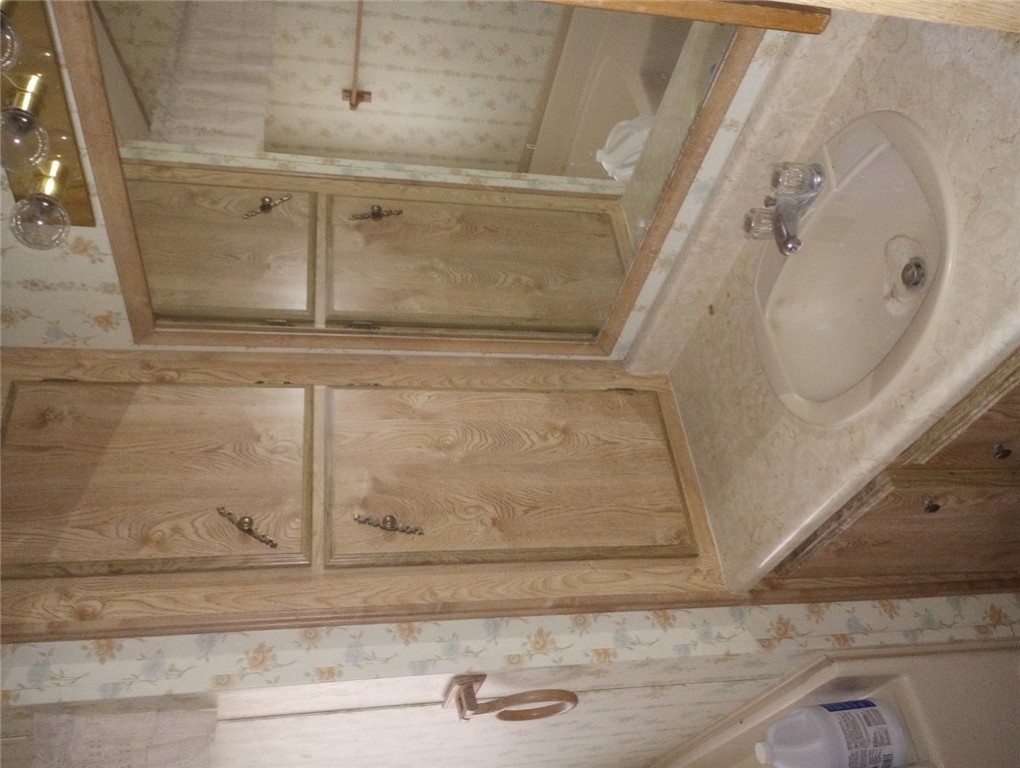 1682 Toro Road Bullhead City, AZ 86442 - Photo 14 of 30 Bathroom featuring wallpapered walls and vanity