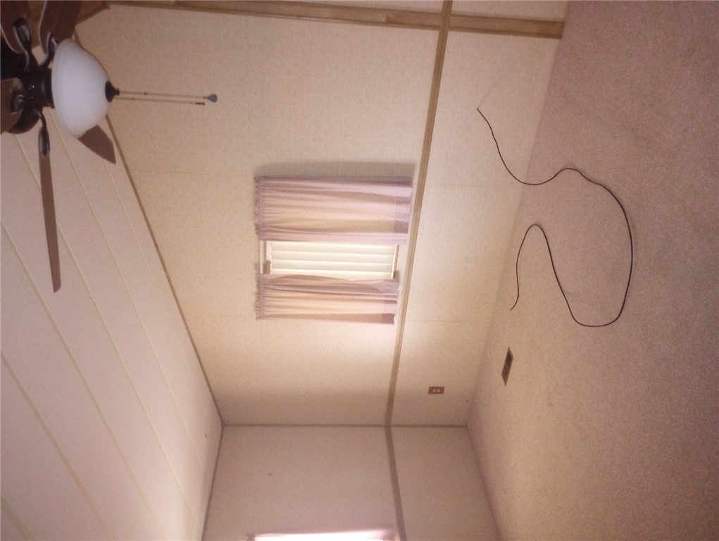 1682 Toro Road Bullhead City, AZ 86442 - Photo 16 of 30 Carpeted empty room with ceiling fan and vaulted ceiling