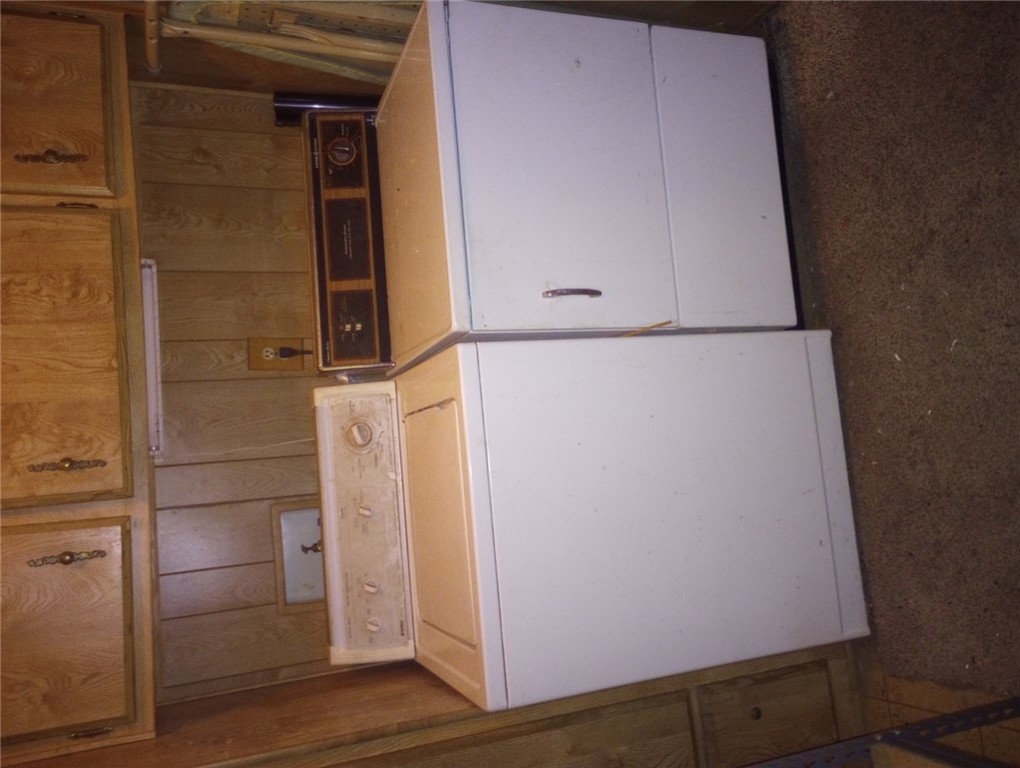1682 Toro Road Bullhead City, AZ 86442 - Photo 24 of 30 Laundry area featuring separate washer and dryer, cabinet space, and wood walls