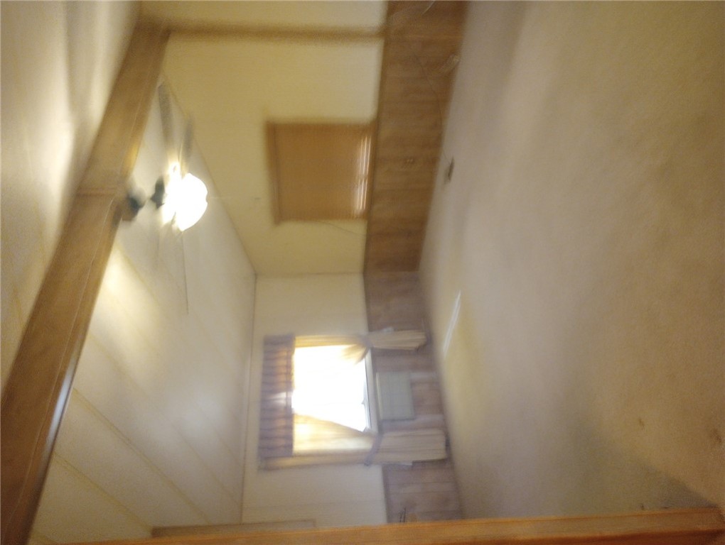 1682 Toro Road Bullhead City, AZ 86442 - Photo 8 of 30 Carpeted empty room featuring a ceiling fan, a wainscoted wall, and wooden walls