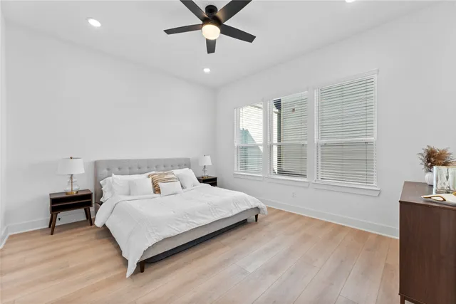 a bedroom with a bed and a ceiling fan