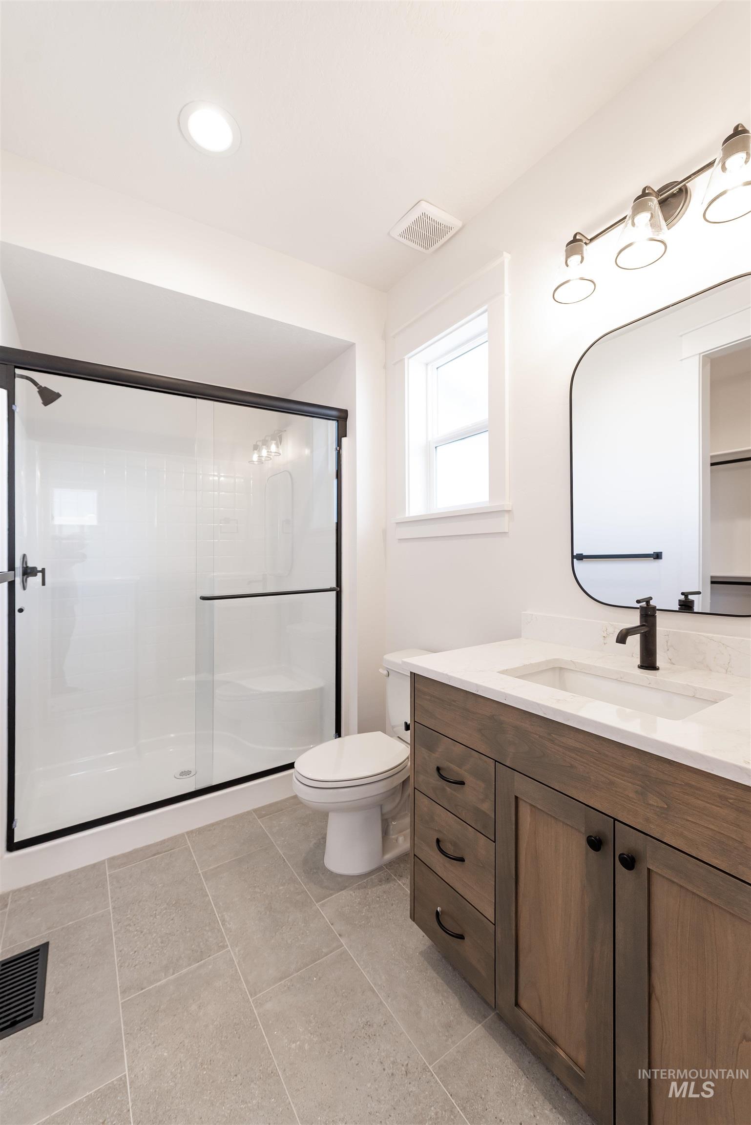 410 South Diesel Way Boise, ID 83716 - Photo 16 of 49 Full bath with vanity, a stall shower, recessed lighting, and light tile patterned floors