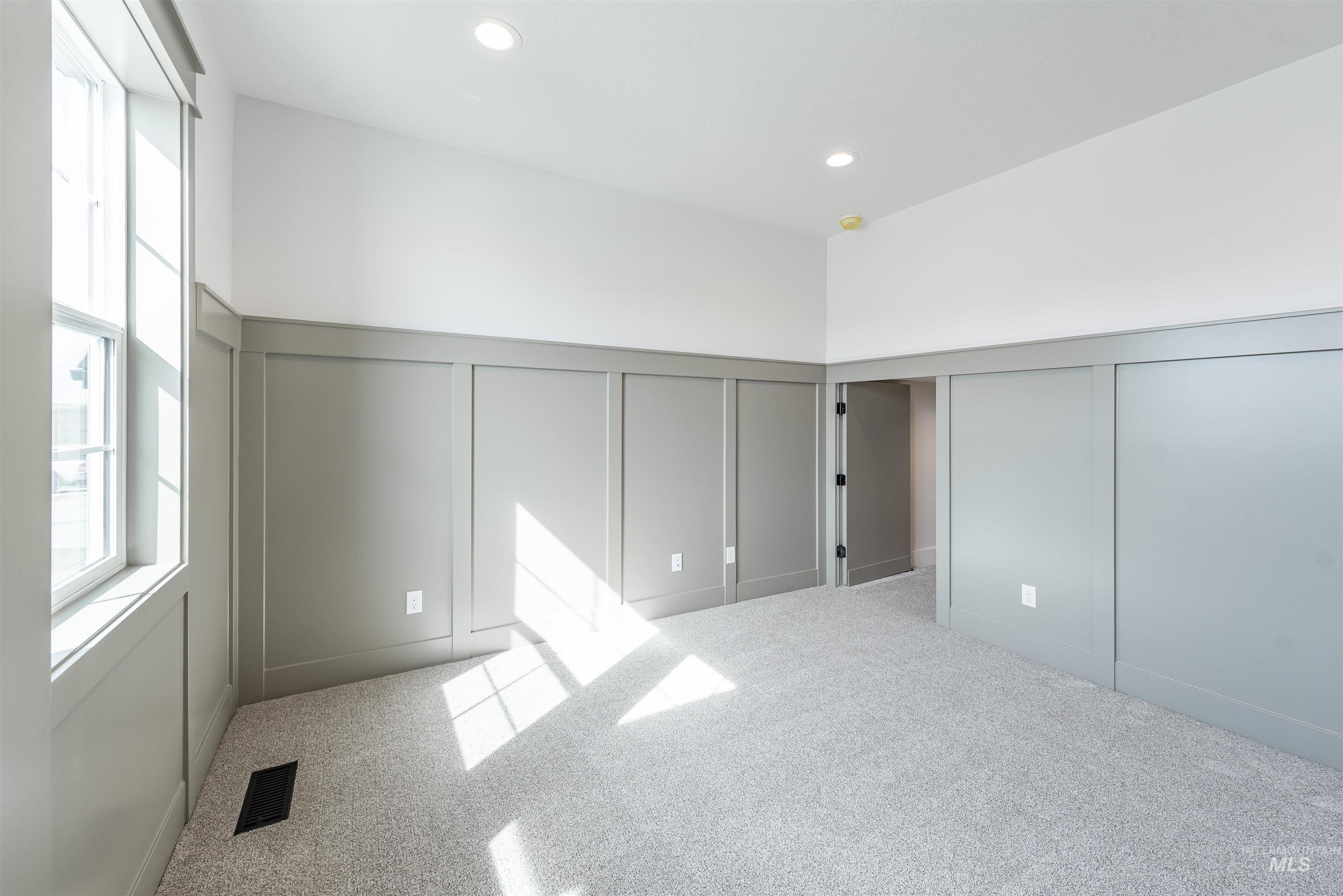 410 South Diesel Way Boise, ID 83716 - Photo 21 of 49 Unfurnished bedroom featuring a decorative wall, light carpet, a wainscoted wall, and recessed lighting