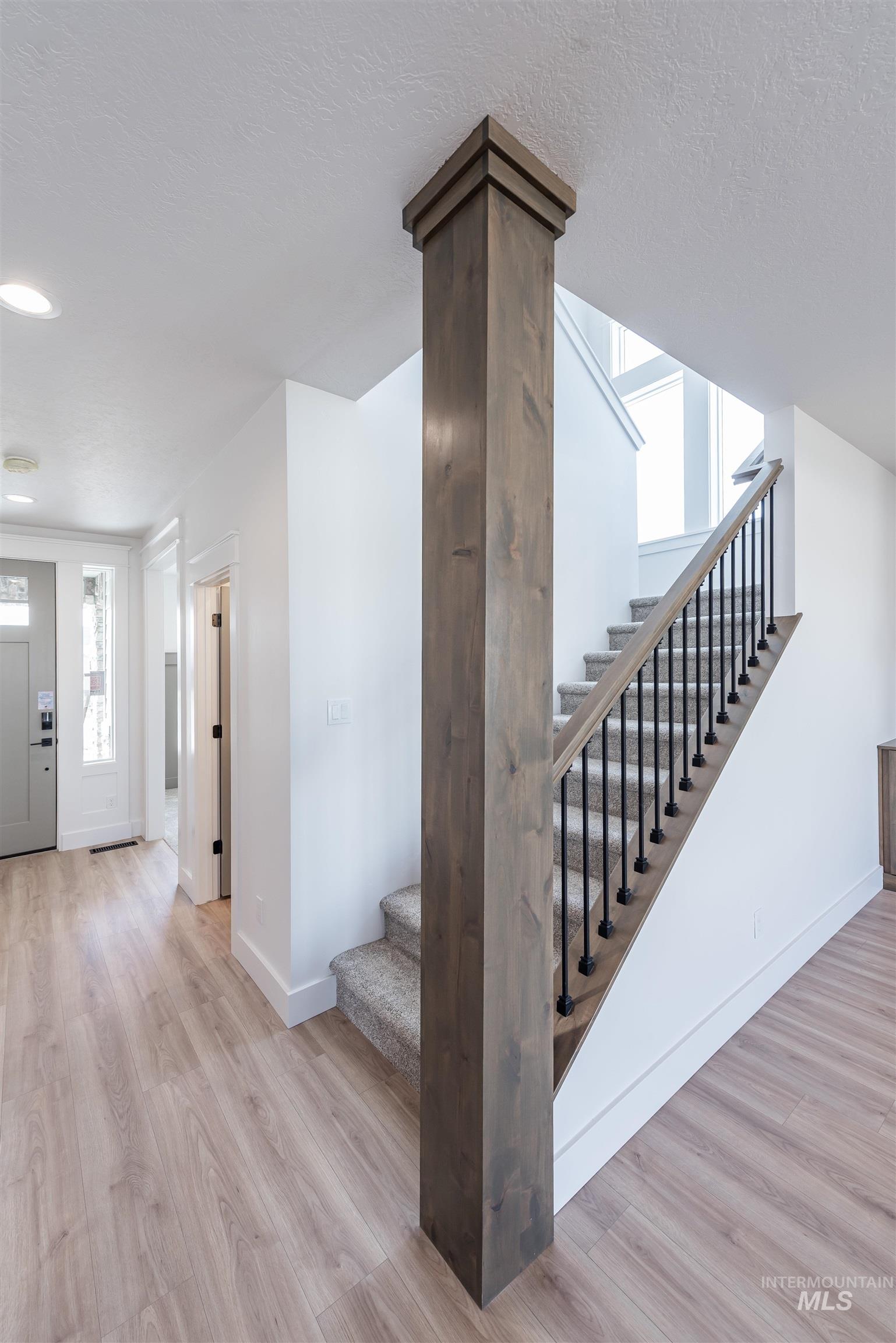 410 South Diesel Way Boise, ID 83716 - Photo 23 of 49 Stairway with wood finished floors and a textured ceiling