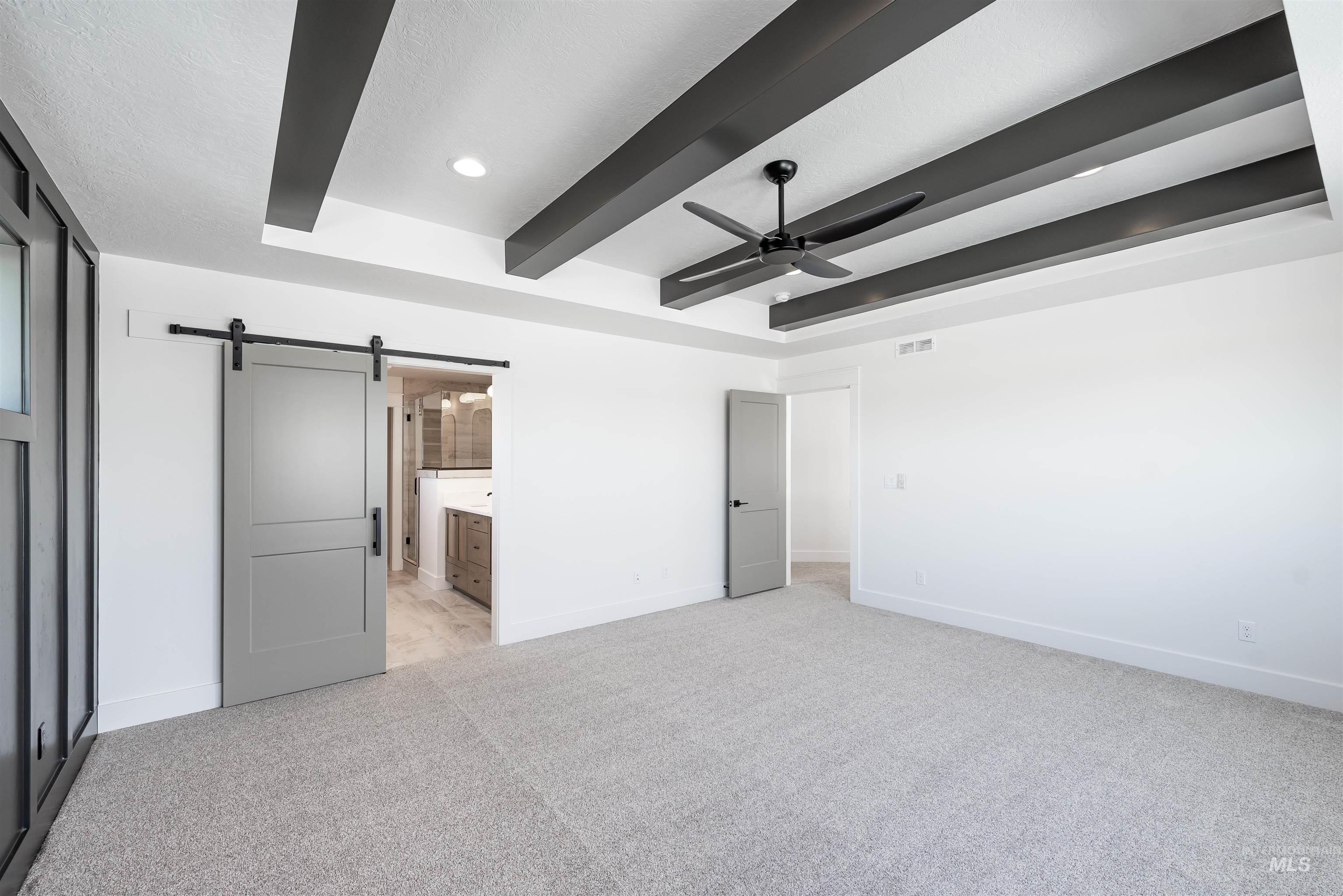 410 South Diesel Way Boise, ID 83716 - Photo 27 of 49 Unfurnished bedroom with a barn door, light colored carpet, a ceiling fan, ensuite bathroom, and recessed lighting