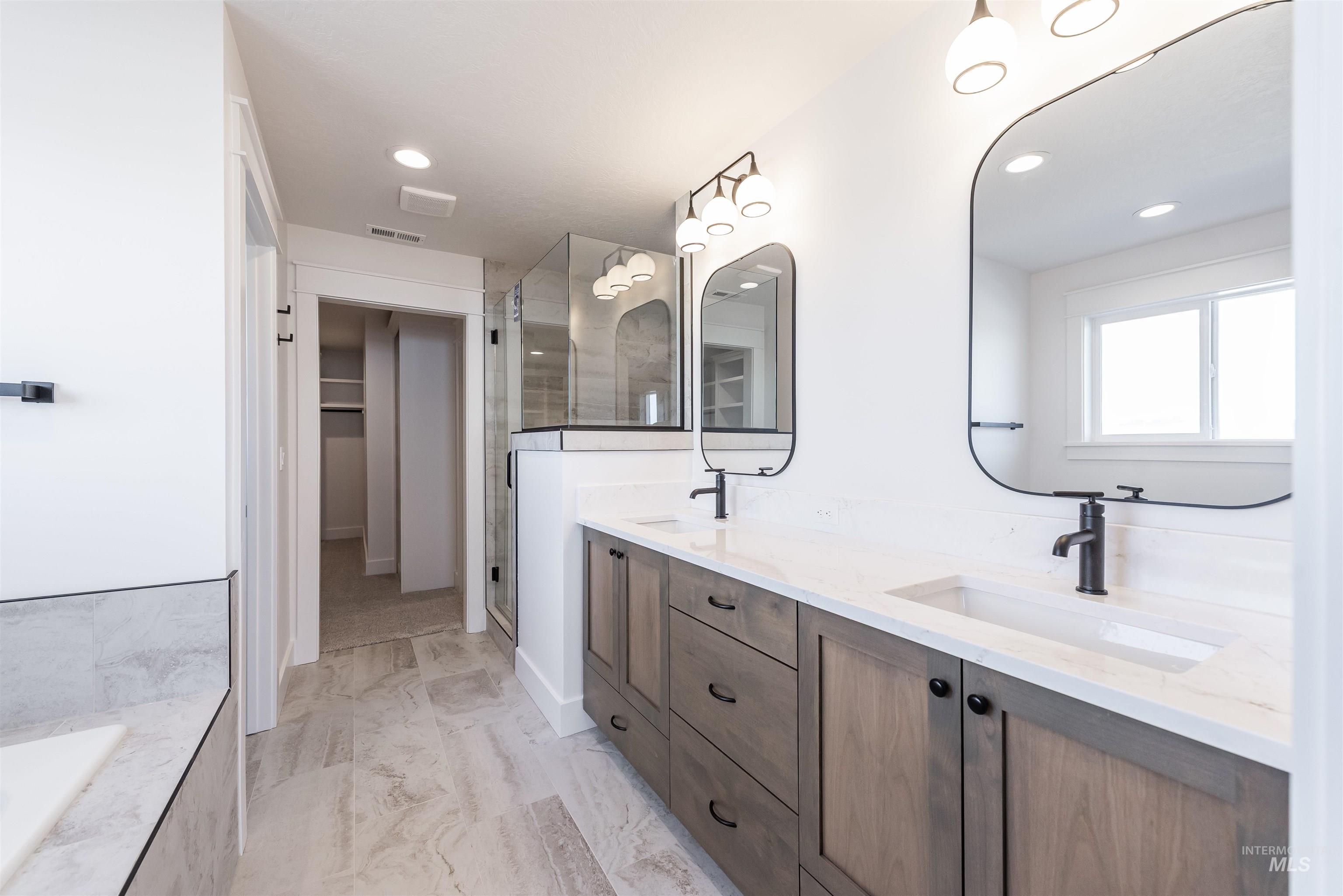 410 South Diesel Way Boise, ID 83716 - Photo 29 of 49 Bathroom featuring double vanity, a stall shower, a walk in closet, recessed lighting, and a garden tub