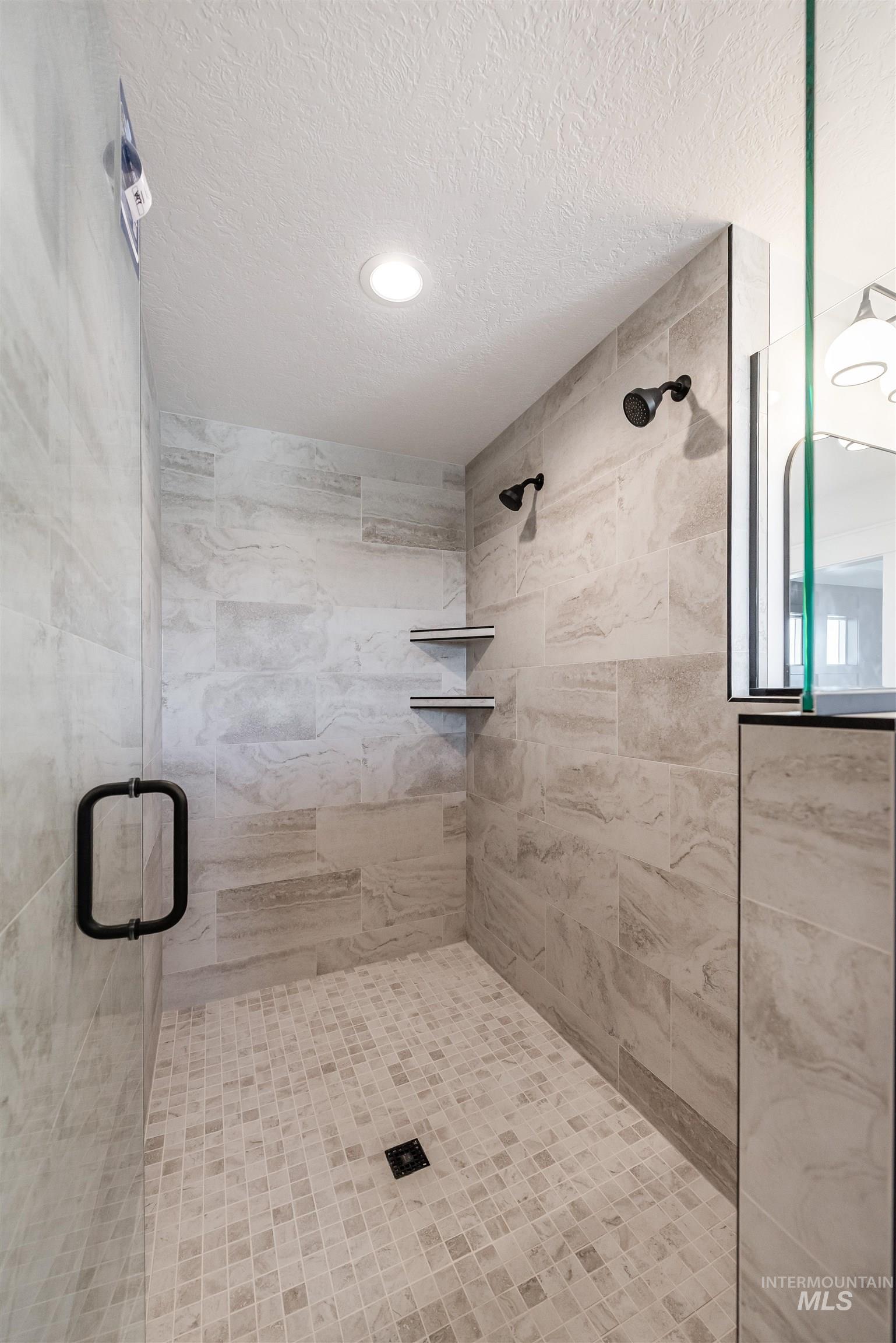 410 South Diesel Way Boise, ID 83716 - Photo 30 of 49 Bathroom featuring a shower stall and a textured ceiling