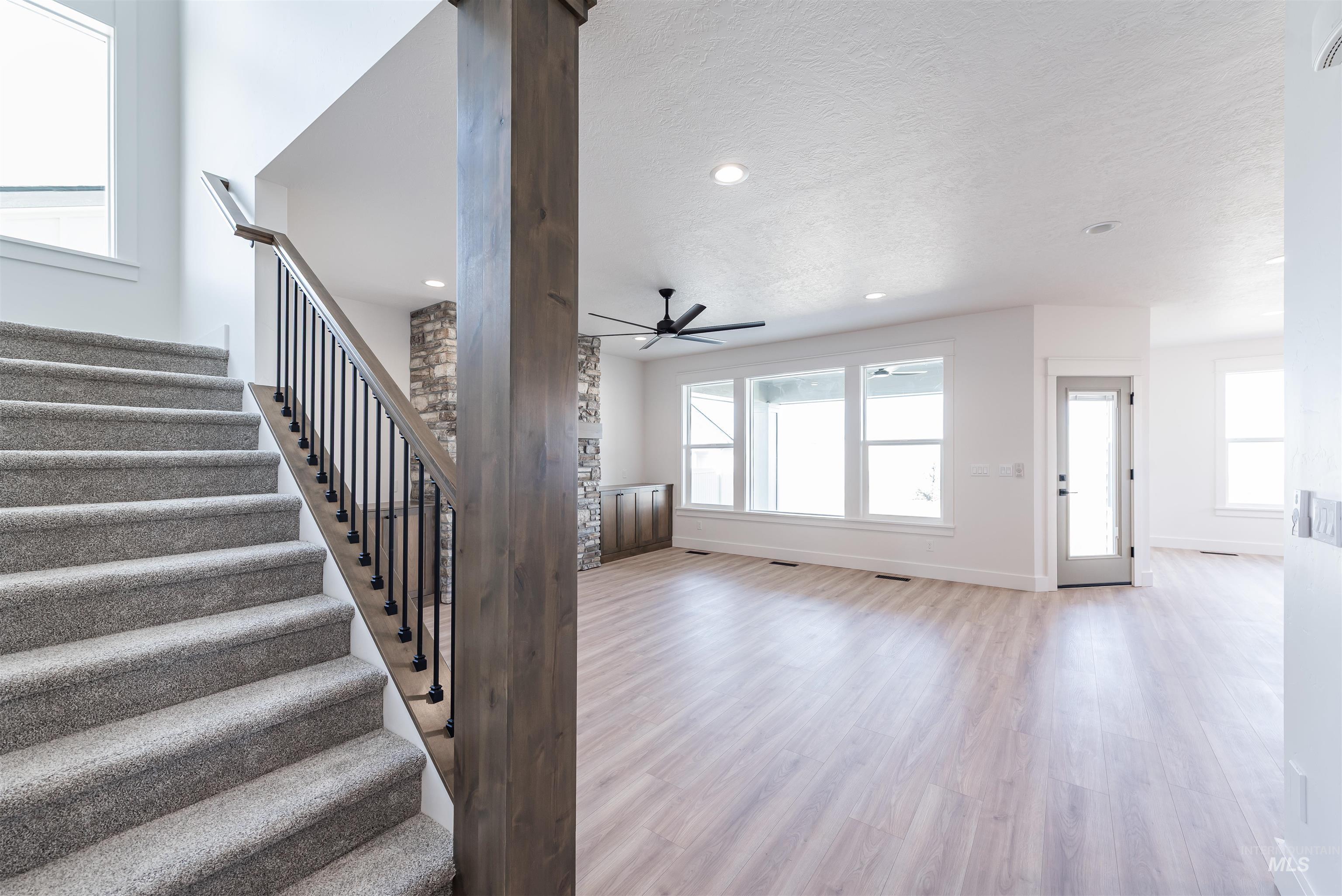 410 South Diesel Way Boise, ID 83716 - Photo 3 of 49 Staircase with wood finished floors, a textured ceiling, recessed lighting, and a ceiling fan