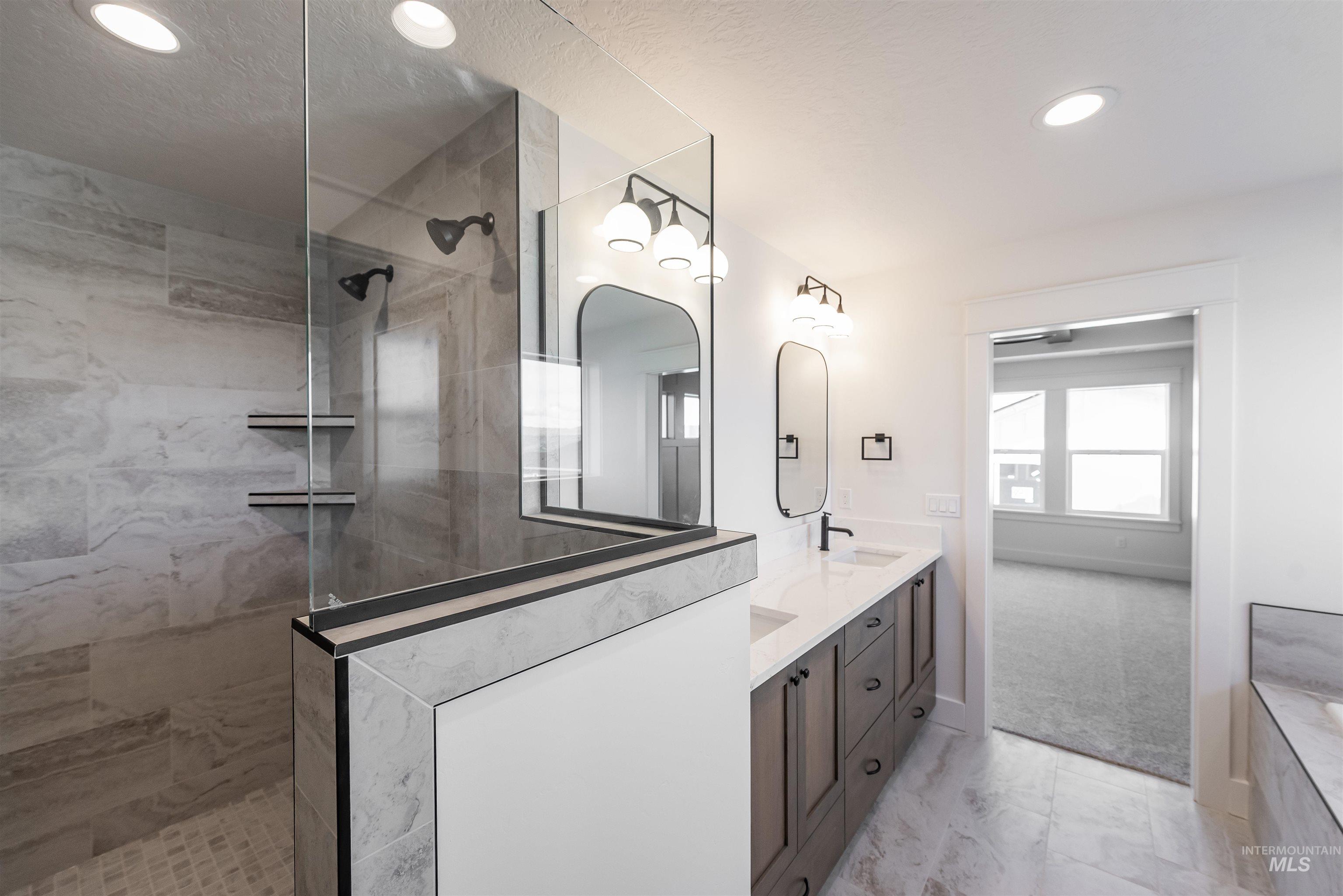 410 South Diesel Way Boise, ID 83716 - Photo 31 of 49 Bathroom featuring double vanity, light marble finish flooring, a walk in shower, and recessed lighting
