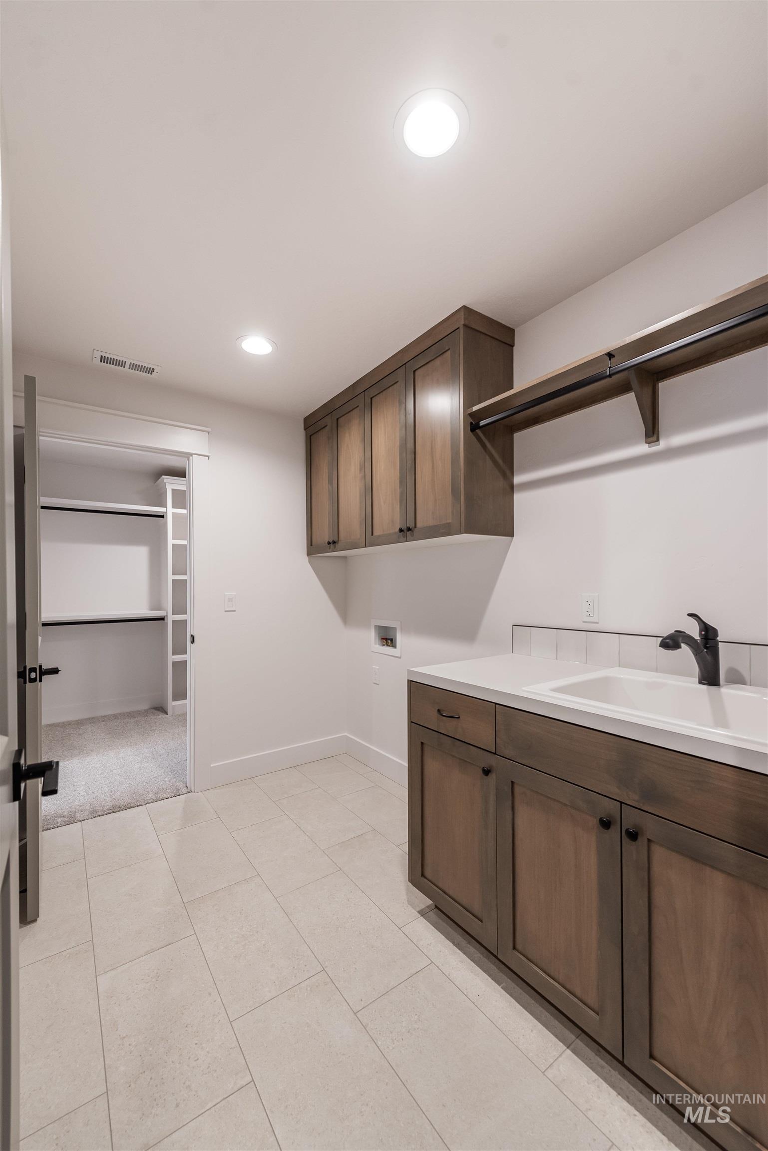 410 South Diesel Way Boise, ID 83716 - Photo 33 of 49 Laundry room with recessed lighting, washer hookup, cabinet space, and light tile patterned flooring