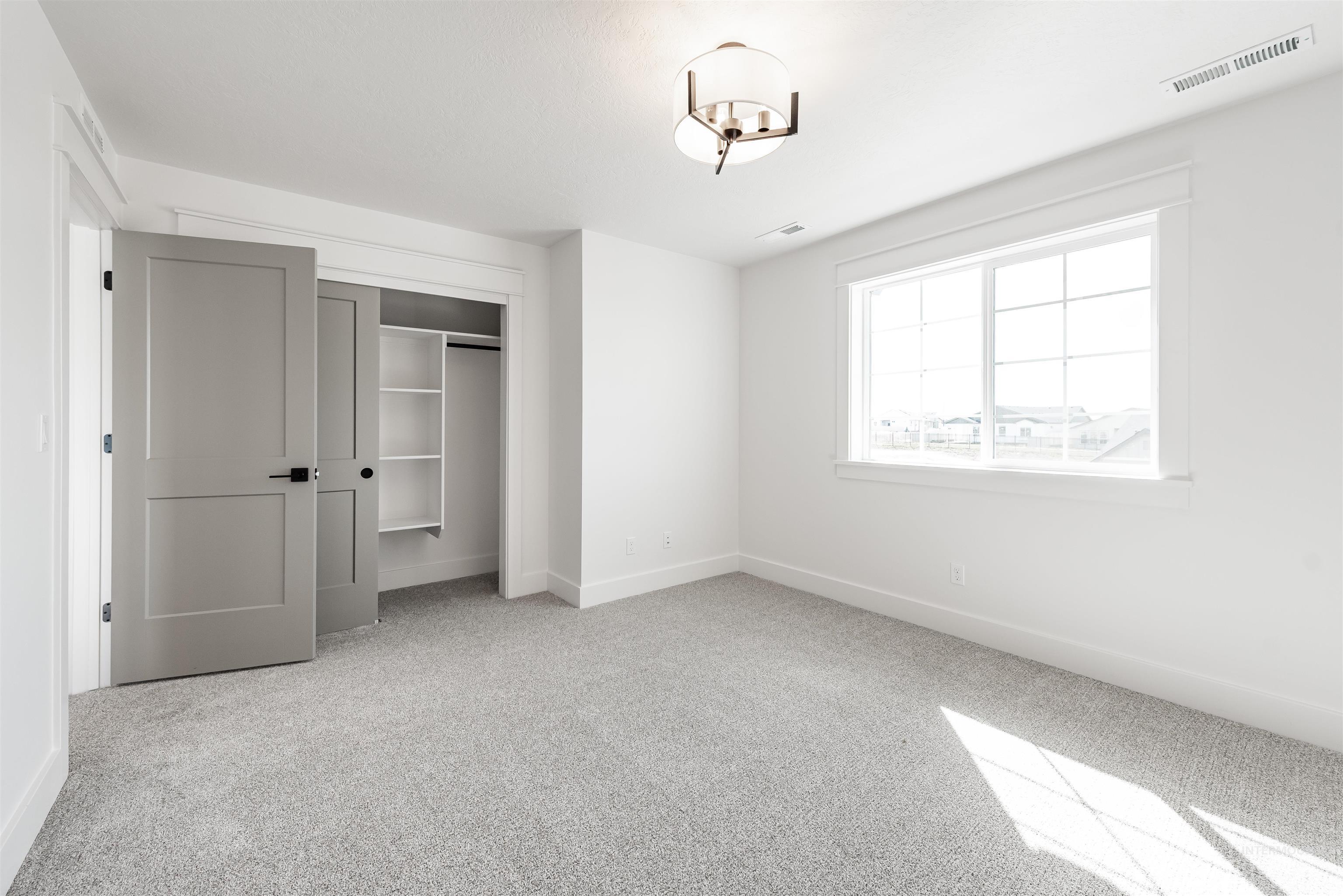 410 South Diesel Way Boise, ID 83716 - Photo 35 of 49 Unfurnished bedroom with light colored carpet and a closet
