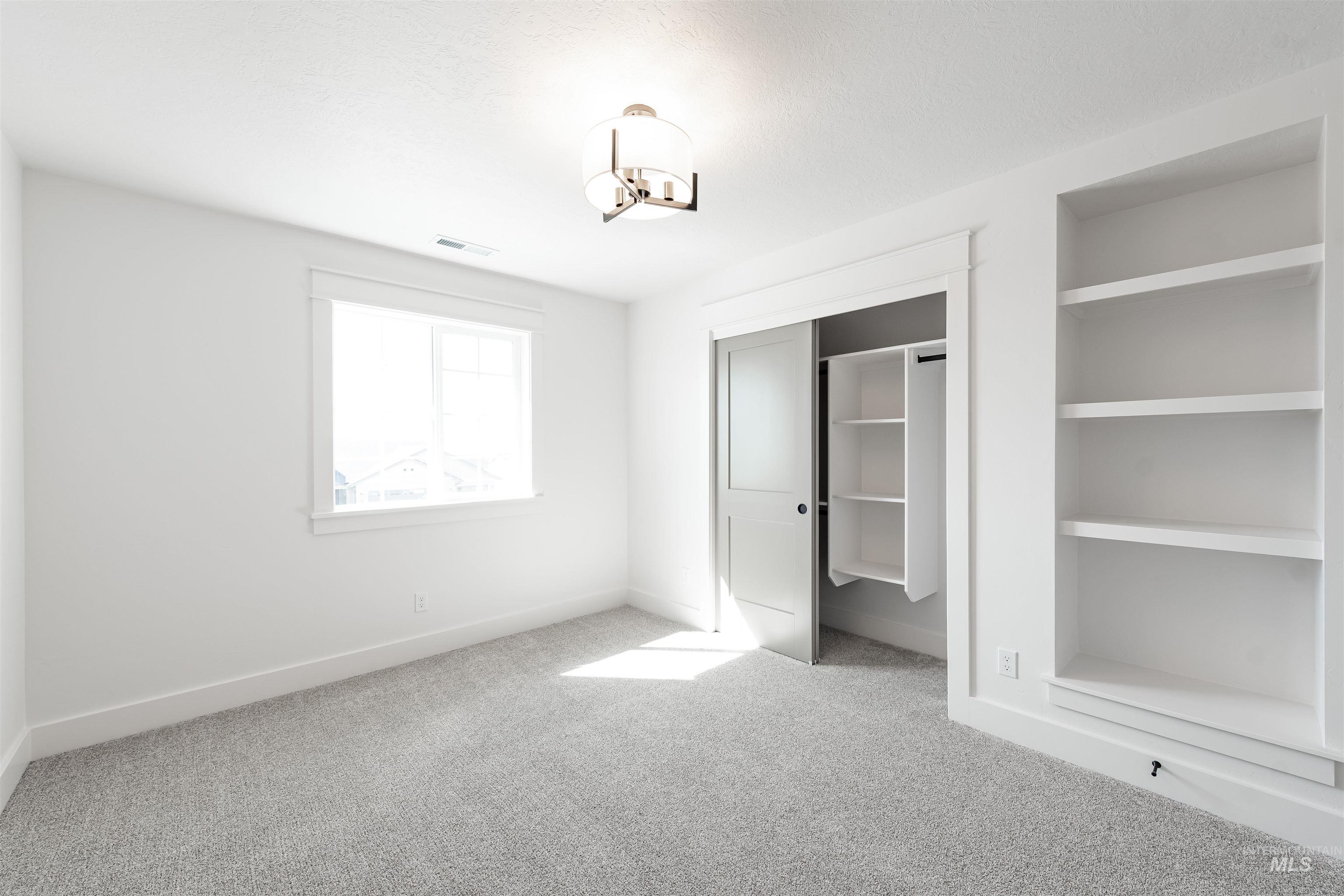 410 South Diesel Way Boise, ID 83716 - Photo 38 of 49 Unfurnished bedroom with light carpet and a closet