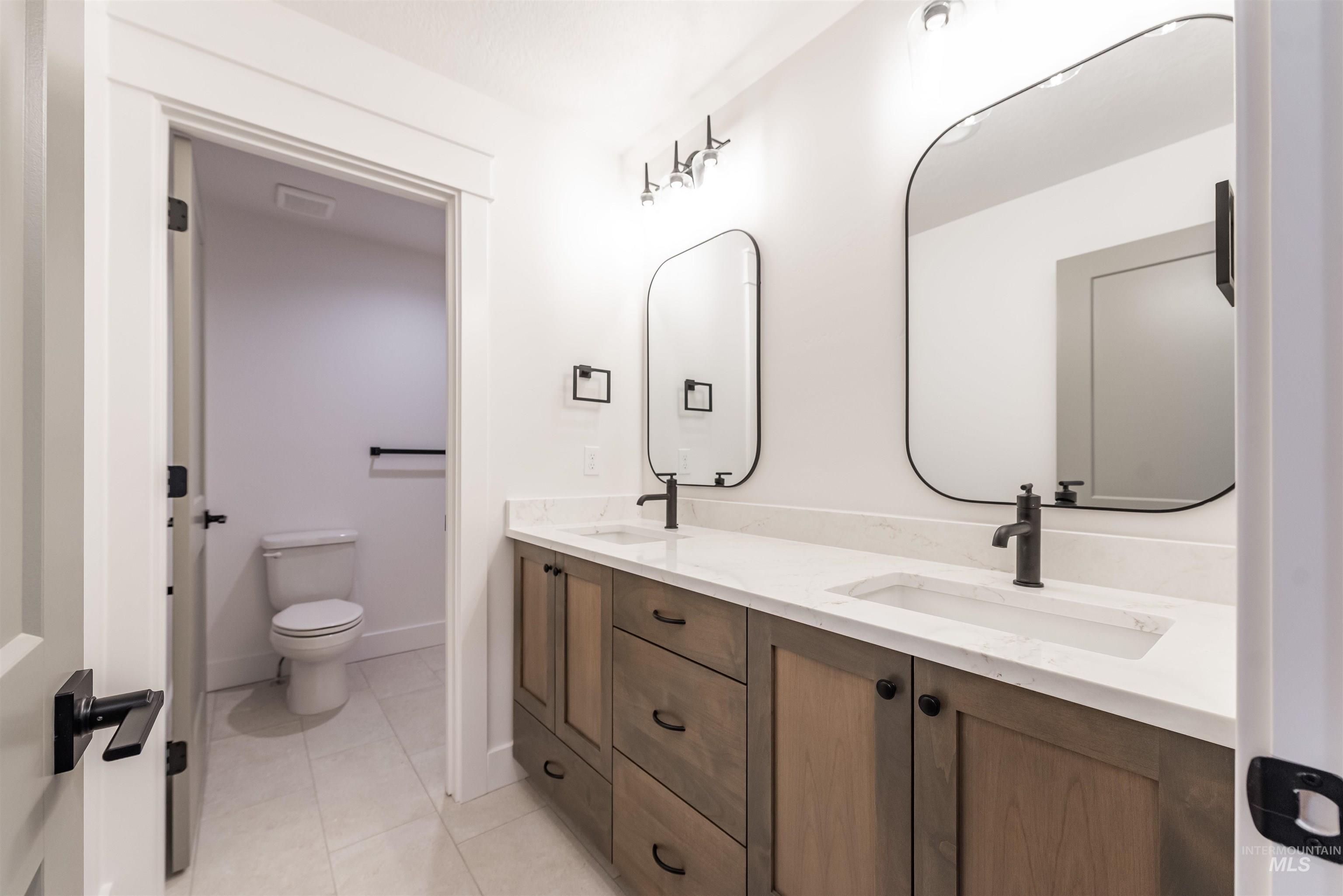 410 South Diesel Way Boise, ID 83716 - Photo 39 of 49 Bathroom featuring double vanity and light tile patterned floors