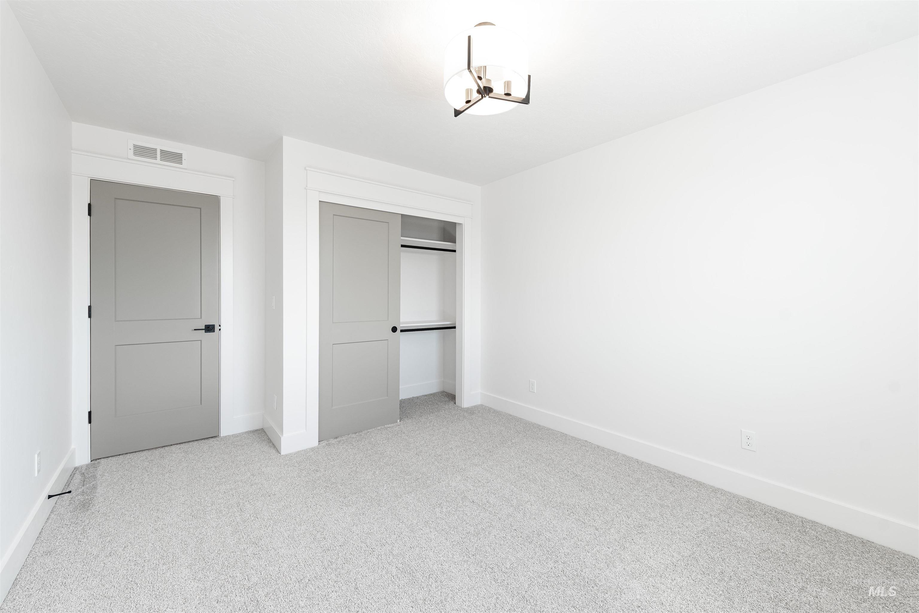410 South Diesel Way Boise, ID 83716 - Photo 42 of 49 Unfurnished bedroom featuring light carpet and a closet