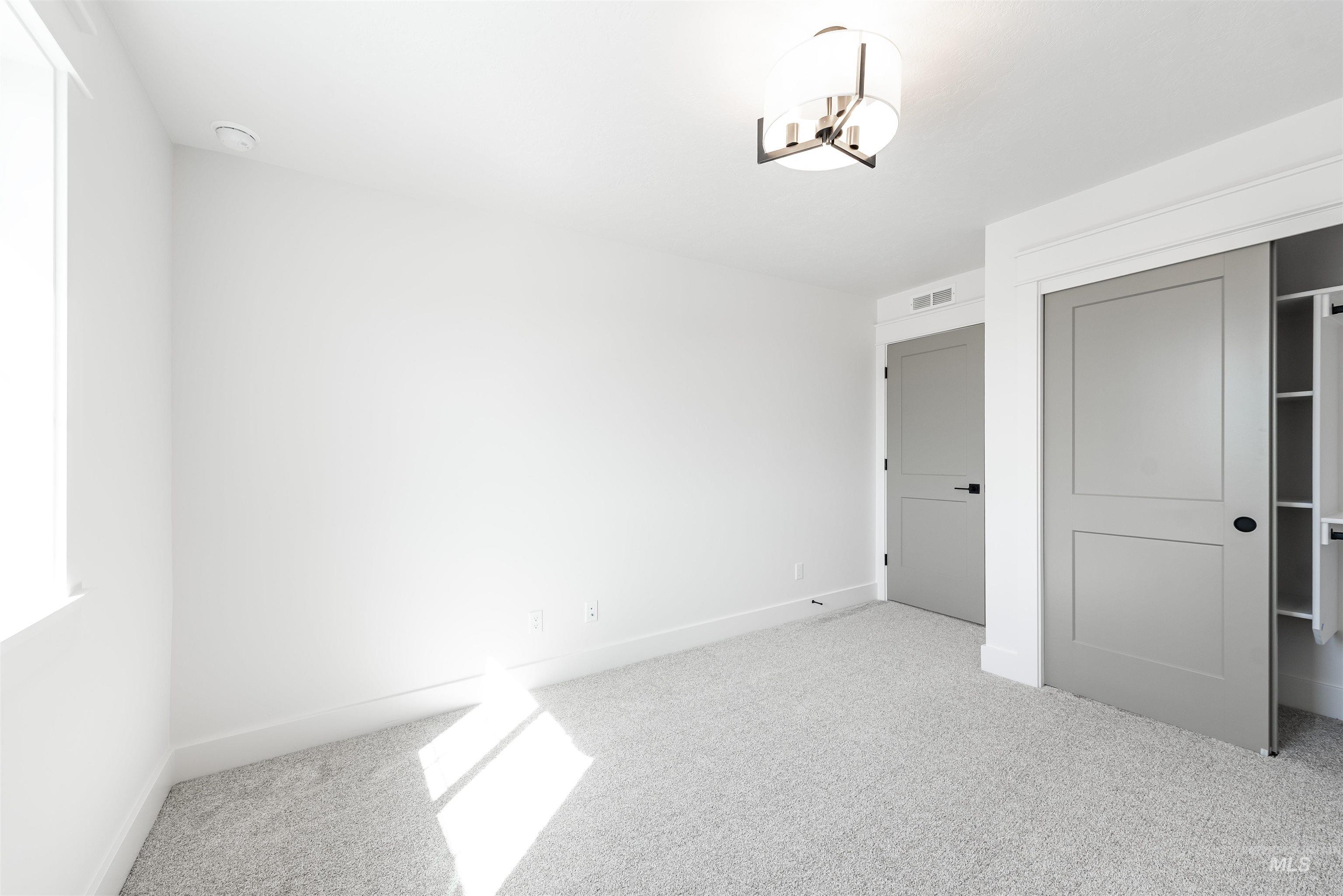 410 South Diesel Way Boise, ID 83716 - Photo 43 of 49 Unfurnished bedroom with light colored carpet and a closet