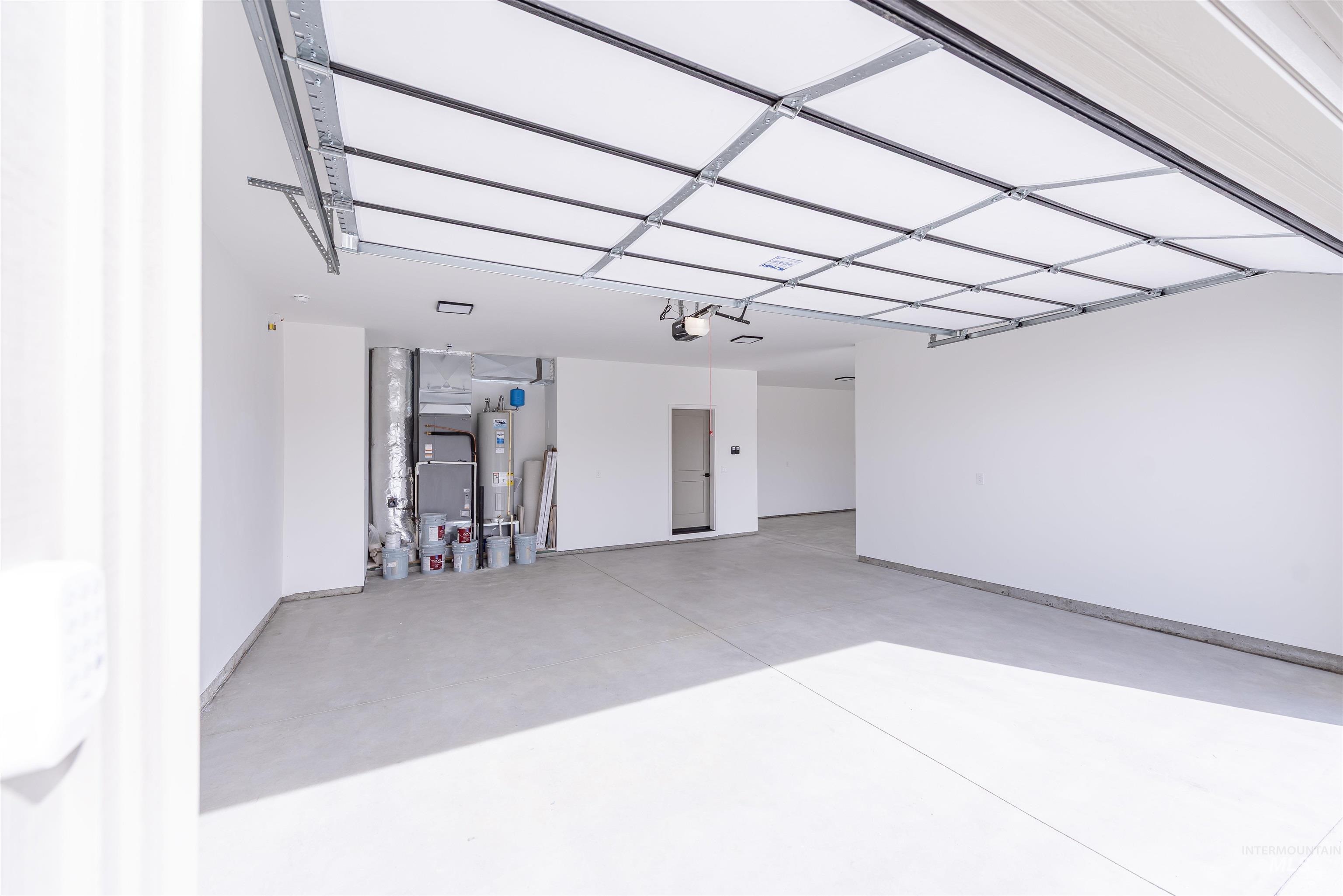 410 South Diesel Way Boise, ID 83716 - Photo 47 of 49 Garage with heating unit and water heater