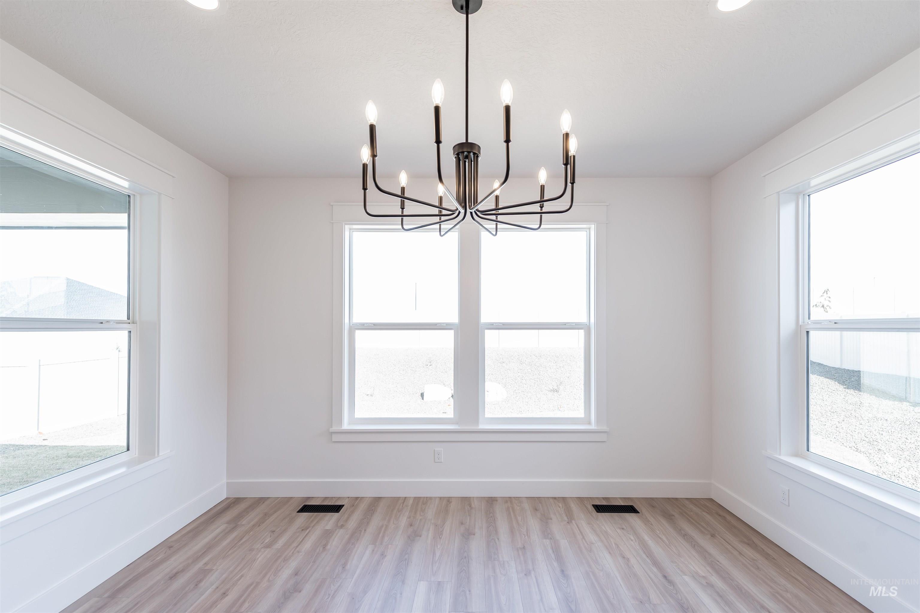 410 South Diesel Way Boise, ID 83716 - Photo 7 of 49 Unfurnished dining area with light wood finished floors and hanging lights