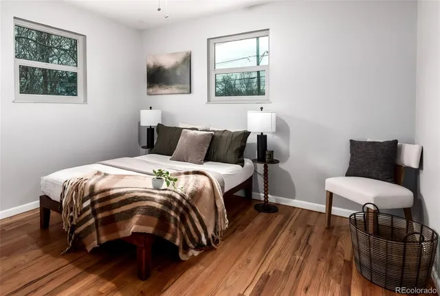 a bedroom with a bed a mirror and a window