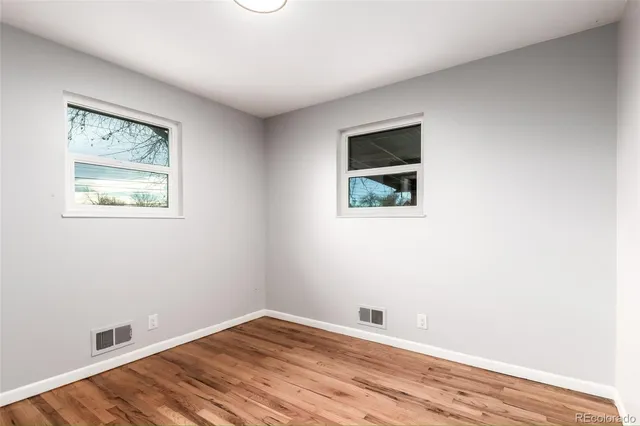 a view of room with window and wooden floor