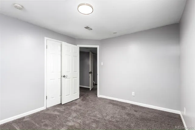 an empty room with closet area