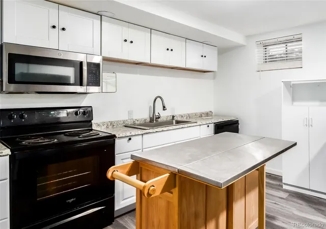 a kitchen with stainless steel appliances a stove a microwave and cabinets