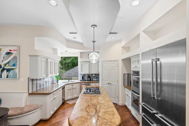 a kitchen with a stove a sink and a window