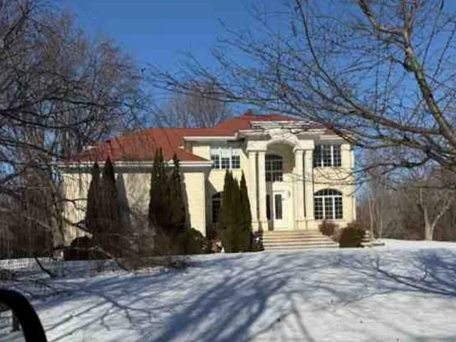 a view of a white house with a outdoor space
