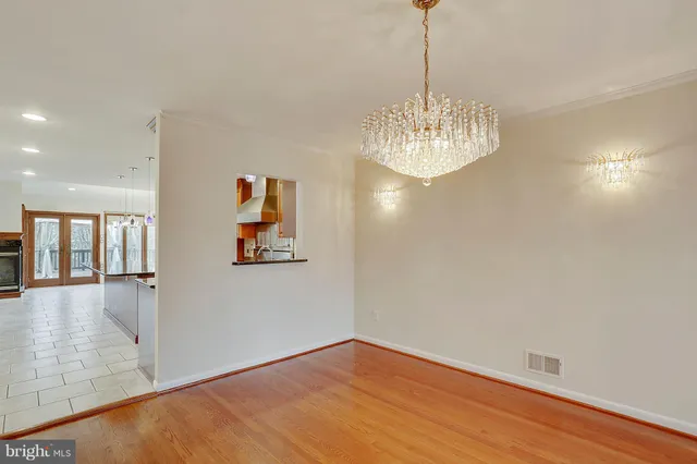 an empty room with large window and stainless steel appliances
