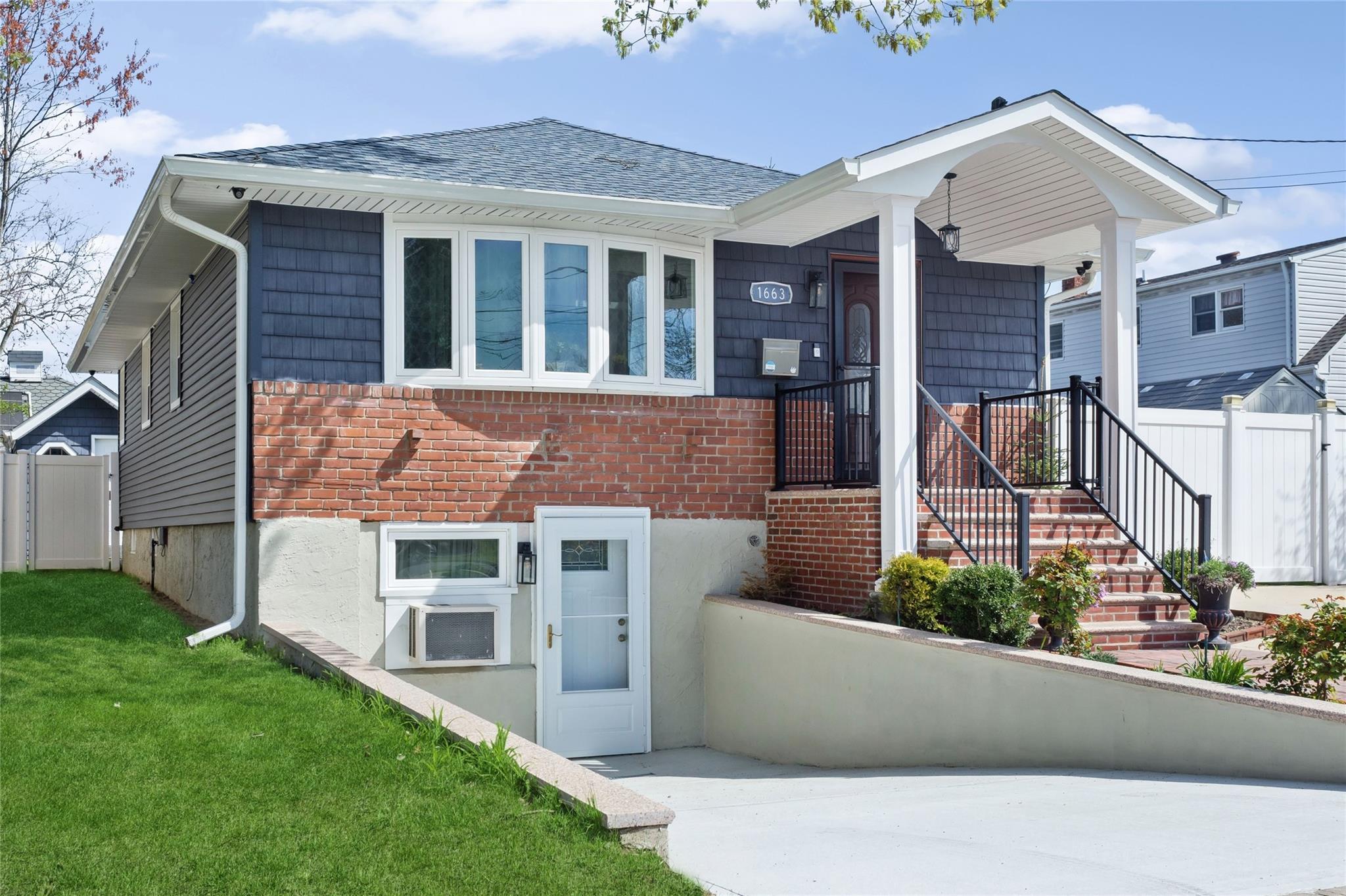 a view of a house with a large window and a yard