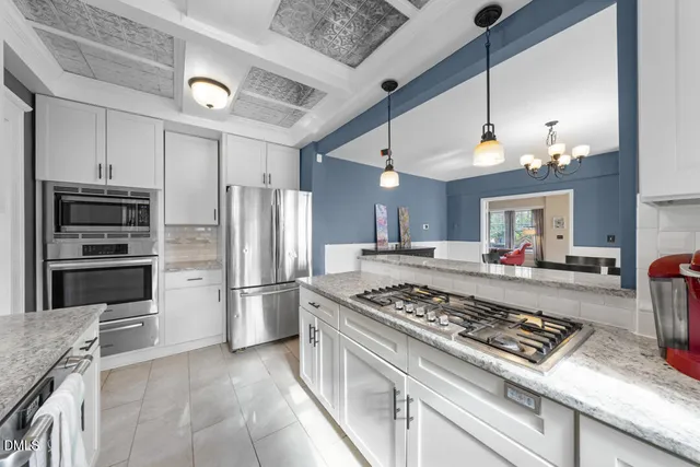 a kitchen with a stove and a refrigerator