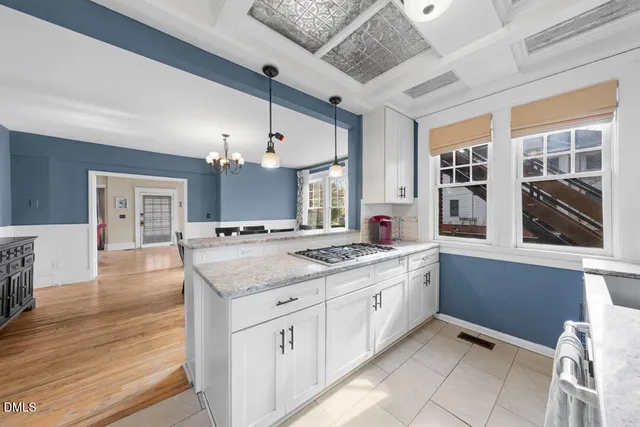 a spacious bathroom with a granite countertop sink a mirror and a shower
