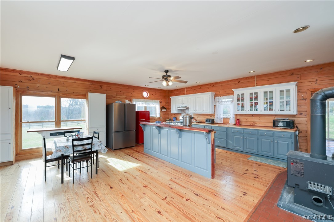 3913 Woodland Church Road Buckingham, VA 23921 - Photo 12 of 50 a kitchen with stainless steel appliances kitchen island granite countertop a stove a refrigerator a dining table and chairs with wooden floor