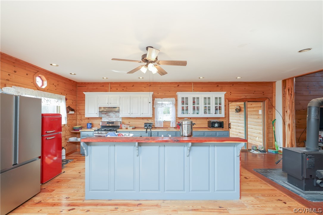 3913 Woodland Church Road Buckingham, VA 23921 - Photo 13 of 50 a view of a kitchen with kitchen island stainless steel appliances a sink and a large window