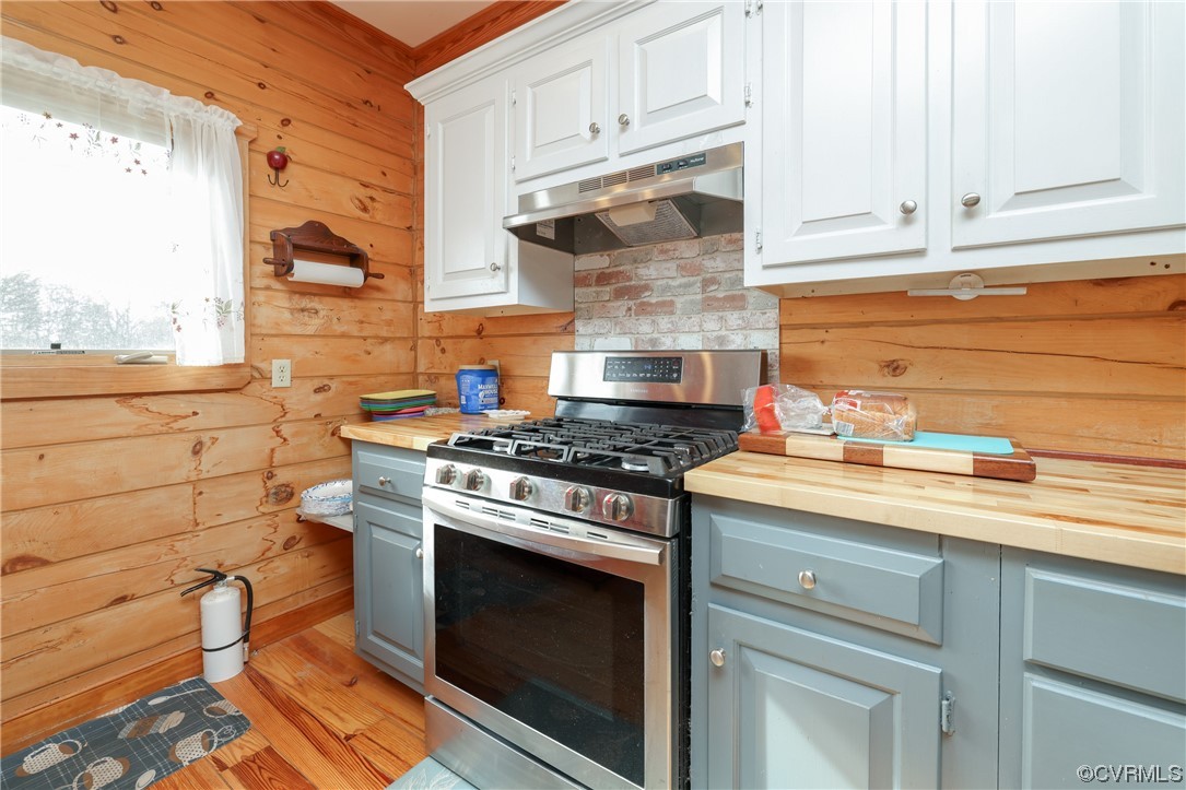 3913 Woodland Church Road Buckingham, VA 23921 - Photo 15 of 50 a kitchen with stainless steel appliances granite countertop a stove and a white cabinets