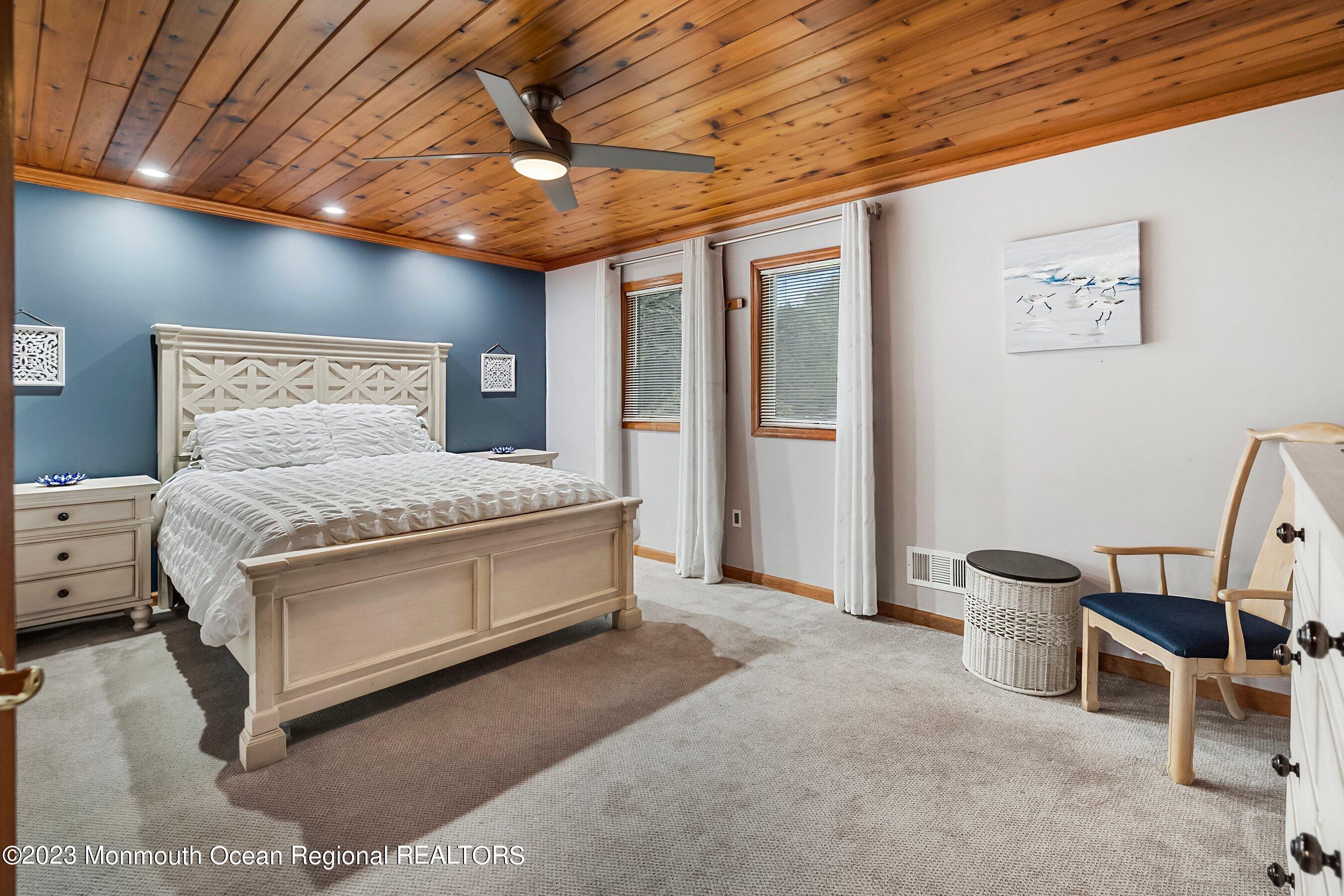 375 Cook Road Jackson, NJ 08527 - Photo 19 of 22 a spacious bedroom with a bed and a chandelier