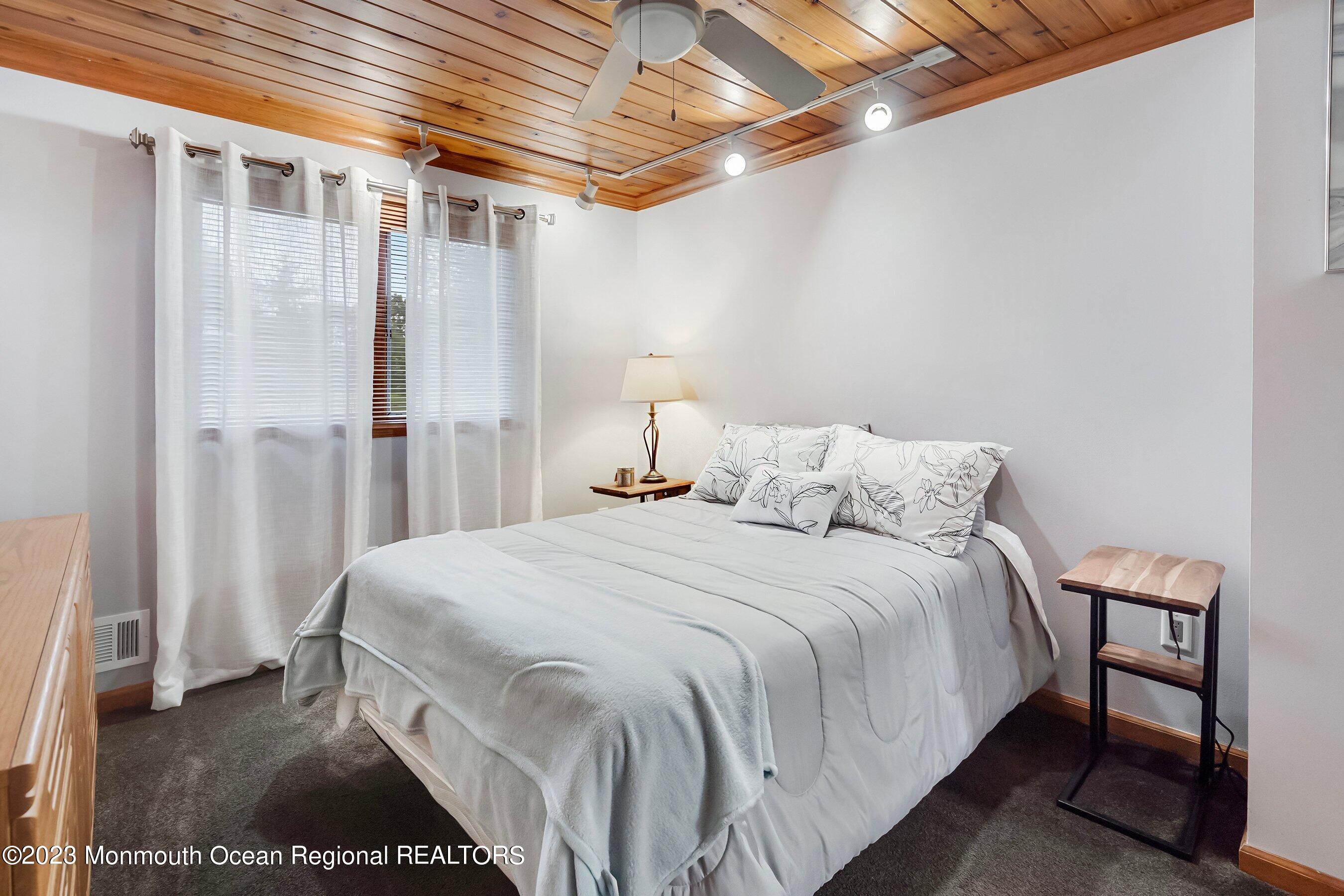 375 Cook Road Jackson, NJ 08527 - Photo 20 of 22 a bedroom with a bed and a table