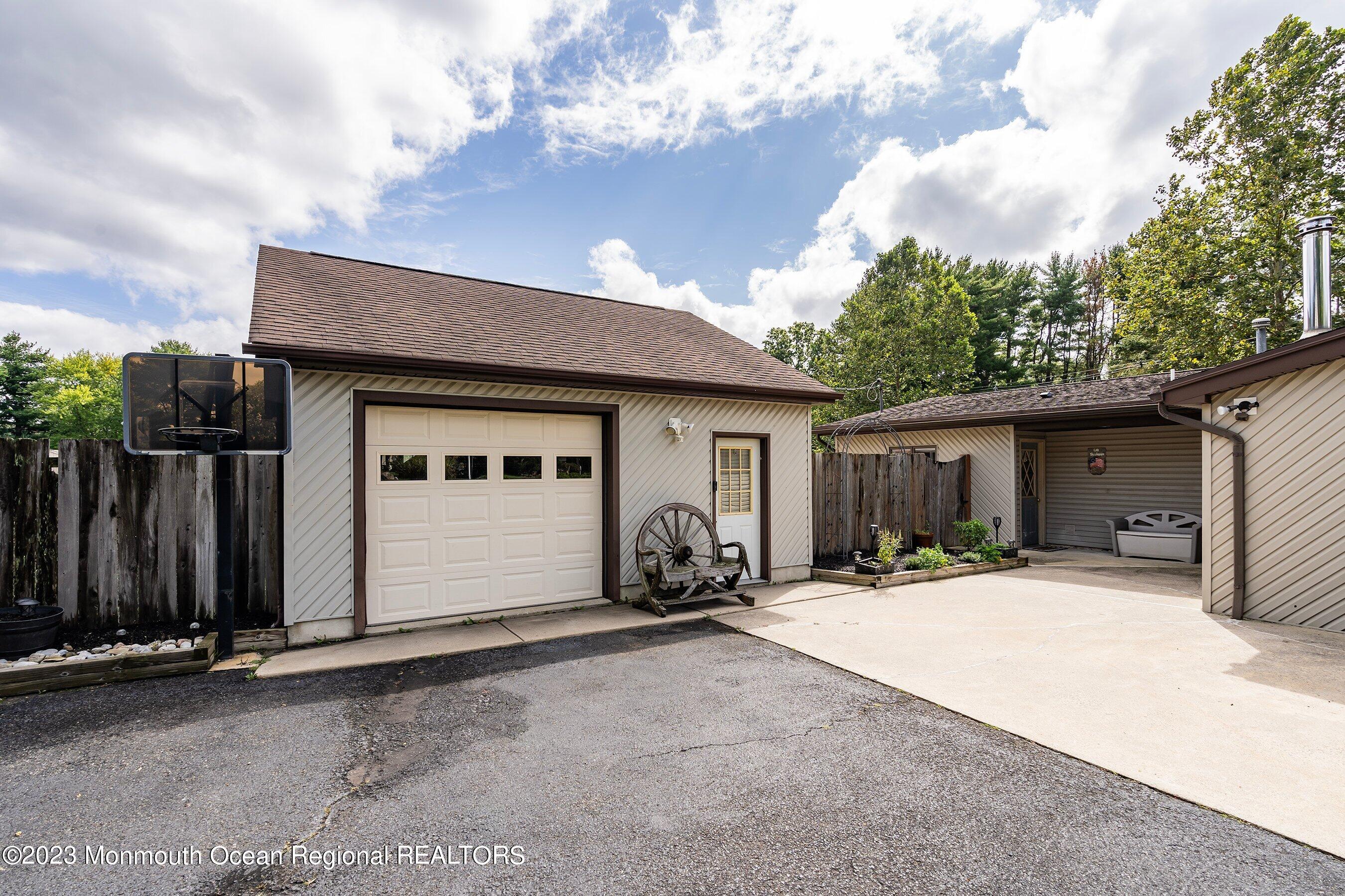 375 Cook Road Jackson, NJ 08527 - Photo 3 of 22 a front view of a house with a yard and garage