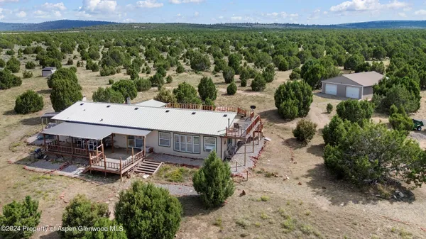 an aerial view of a house with a yard