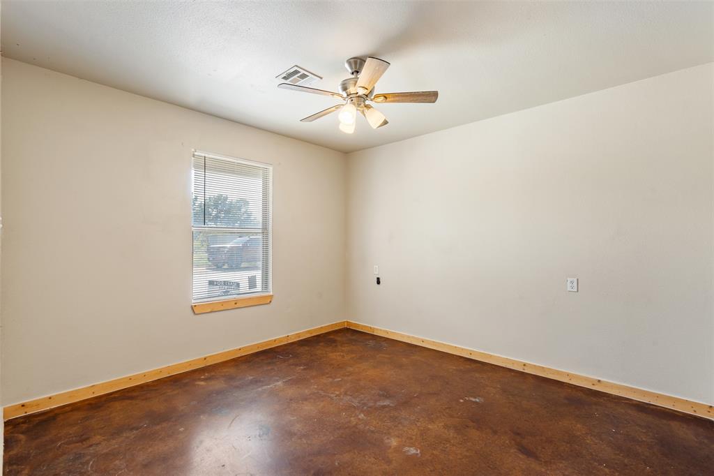 13001 Owen Lane, Unit 13005 Thackerville, OK 73459 - Photo 9 of 15 Empty room featuring concrete floors and ceiling fan