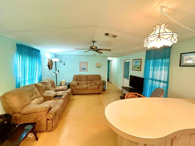 a living room with furniture chandelier and a chandelier