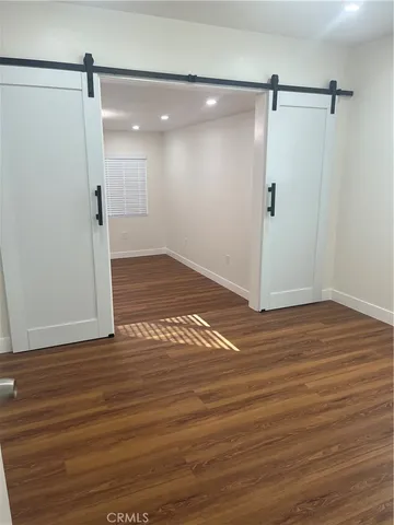 a view of a room with wooden floor