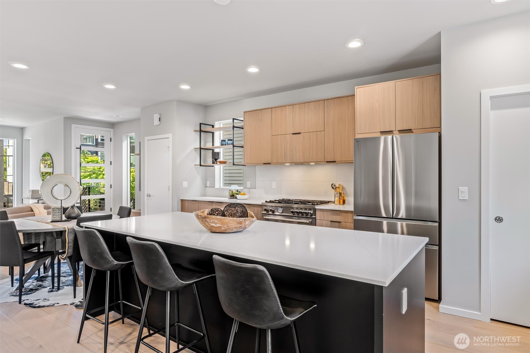 4460 Midvale Avenue North Seattle, WA 98103 - Photo 13 of 40 a kitchen with a dining table chairs refrigerator and cabinets