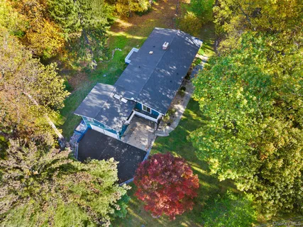 an aerial view of a house with a yard