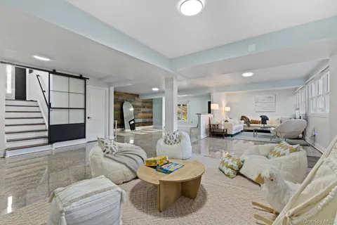 a living room with furniture and kitchen view